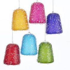 six different colored bell ornaments hanging from strings