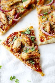 several slices of pizza with sauce, onions and chicken