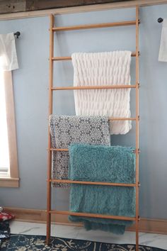 the ladder is leaning against the wall with towels on it