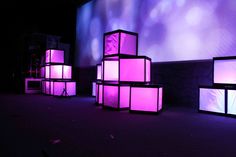 several cubes are lit up with purple lighting