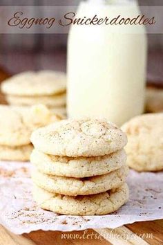 a stack of cookies sitting on top of a table next to a glass of milk