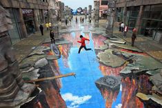 a person jumping in the air on a street painted with blue and red paint,