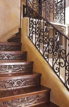 the stairs are made of wood and wrought iron