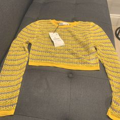 Knit Long Sleeve Crop Top Yellow Fitted Knit Sweater, Fitted Yellow Knit Sweater, Yellow Knit Top For Winter, Yellow Textured Knit Crew Neck Top, Winter Yellow Knit Top, Yellow Knitted Crew Neck Top, Yellow Long Sleeve Pointelle Knit Sweater, Yellow Knit Long Sleeve Top, Trendy Yellow Crochet Top For Spring