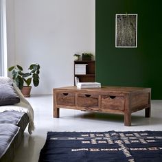 a living room with green walls and furniture