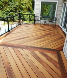 a wooden deck with chairs and table on it