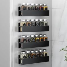 three black shelves holding spices and condiments