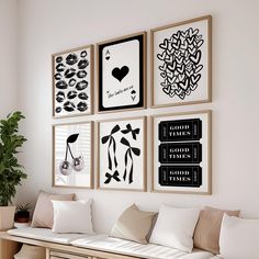 a living room filled with furniture and framed pictures on the wall above it's coffee table