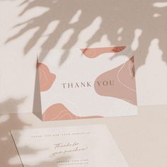 a thank you card and envelope on a table