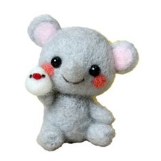 a small gray stuffed animal with red eyes