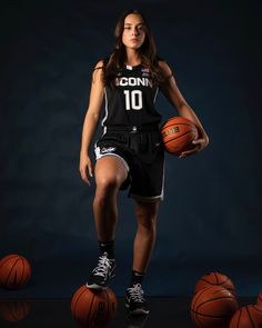 a female basketball player is posing for a photo