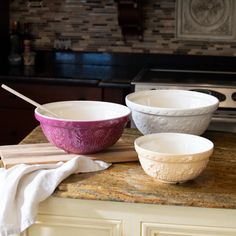 three bowls are sitting on a counter top