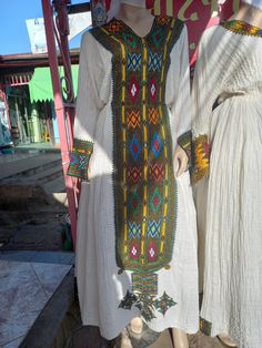 This gorgeous Authentic Traditional Axum fetil is hand woven by traditional Ethiopian weavers ( shmane) and its hand embroiderd by traditional embroidery artisans using Ethiopian cotton. The detailing on these dresses are impressive and intricate . Scarf and nexela included . Gently wash by hand Traditional Embroidery, Dress Clothes For Women, Hand Woven, Switzerland, Favorite Outfit, Art Collection, Hand Weaving, Dress Outfits, Bathing Beauties