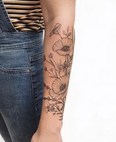 a woman with a flower tattoo on her arm