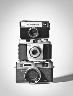 two old cameras sitting on top of each other in front of a white background with the words promtheus