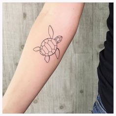 a small turtle tattoo on the arm