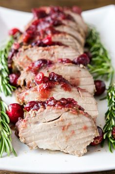 cranberry rosemary pork tenderloin on a white plate