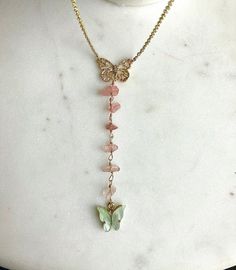 "Transformation Lariat Necklace 🦋 \"We delight in the beauty of the butterfly but rarely admit the changes it has gone through to achieve that beauty\" - Maya Angelou 💙 This is a gold lariat design made out of green fluorite stone (the butterfly) and genuine pink polished cherry quartz ✨ The chain can come in a either gold filled or gold plated material. The gold filled chain never tarnished and holds up extremely well to water, whereas gold plated chains should not be exposed to moisture in o Adjustable Butterfly Pendant Necklace, Butterfly Charm Necklaces For Jewelry Making, Bohemian Butterfly Charm Necklace As Gift, Bohemian Butterfly Charm Necklace Gift, Bohemian Necklace With Butterfly Charm, Bohemian Butterfly Charm Jewelry For Jewelry Making, Bohemian Jewelry With Butterfly Charm Dangle, Bohemian Jewelry With Butterfly Charm For Jewelry Making, Bohemian Dangle Jewelry With Butterfly Charm