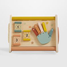 a wooden toy with magnets and numbers on it's side, in the shape of a hand