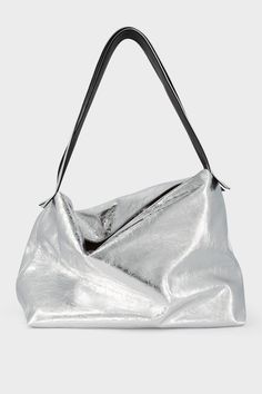 A large metallic silver shoulder bag with two long handles. The handbag is designed as a carry-all travel bag made of fine Italian leather. Perfect Travel Bag, Statement Bag, Quiet Luxury, Carry All Bag, Day Bag, Everyday Bag, Travel Style, Italian Leather, Travel Bag