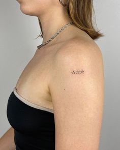 a woman with a small tattoo on her shoulder