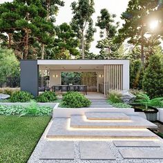 a modern garden with steps leading up to the patio and dining room in the background