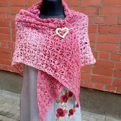 This beautiful women's scarf is hand crocheted from Alize angora in pink. Photo attached. The shawl is crocheted with an original openwork pattern that any woman will like. The top of the shawl is a slightly darker pink than the bottom. Shawl length 200 cm. Shawl width 75 cm. The shawl is accompanied by a handmade wooden brooch in the shape of a heart. The brooch allows you to secure the scarf in any way convenient for you. The shawl will keep you warm and add charm. The shawl is hand knitted wi One Size Crochet Lace Shawl, Pink One Size Shawl, Handmade Yarn Shawl Scarf, Handmade Yarn Shawl Scarves, Hand Knitted Shawl Wrap, Winter Gift Shawl, Bohemian Crochet Shawl As A Gift, Pink Crochet Lace Shawl In Bohemian Style, Bohemian Pink Shawl With Crochet Lace