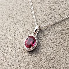 "Ruby and Diamond Pendant 14k White Gold pendant is featuring a 4.62X5.95mm Oval Genuine Ruby .69ct . This Beautiful Ruby has a Halo of .07ct Genuine Diamonds surrounding it. Classic and beautiful. **Ruby is the official July Birthstone** **Diamond is the official April Birthstone** **This listing is for the pendant only. Chain not included, for display purposes only. 14k Yellow Gold chains available for purchase upon request. **Please feel free to contact me anytime, if you have any questions o Oval Ruby Jewelry With Brilliant Cut, Oval Ruby Necklaces In White Gold, White Gold Oval Lab-created Ruby Jewelry, Red Oval Diamond Cut Necklace, Oval Lab-created Ruby In White Gold Jewelry, Oval Lab-created Ruby Jewelry In White Gold, White Gold Oval Ruby Necklaces, Oval Brilliant Cut Lab-created Ruby Jewelry, Fine Jewelry Ruby Oval Pendant Necklace