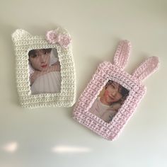 two crocheted photo frames are sitting next to each other