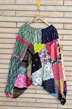 a multicolored skirt hanging on a brick wall