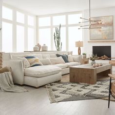 a living room filled with furniture and a fire place in front of a large window