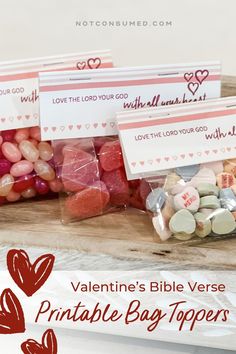 valentine's bible verse printable bag toppers on a wooden tray with candy