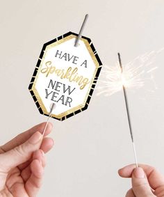 someone holding a sparkler with the words have a sparkling new year on it,