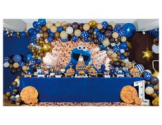 a blue and gold dessert table set up for a cookie monster birthday party with balloons