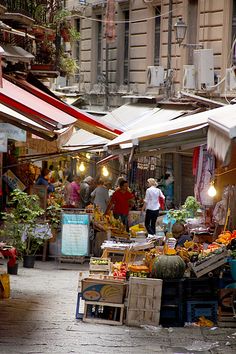 an outdoor market with lots of fruit and vegetables