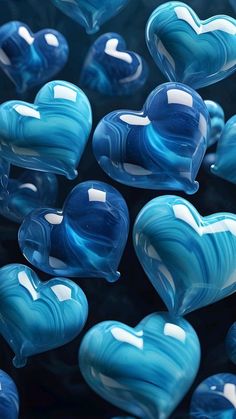 many blue glass hearts are in the shape of heart's on a black background