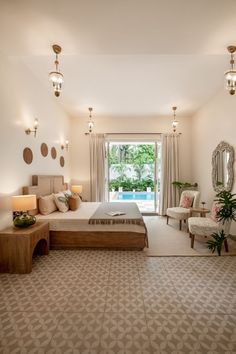 a bedroom with a large bed sitting in the middle of it next to a window