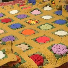 there is a crocheted blanket that has been made into a flowered afghan