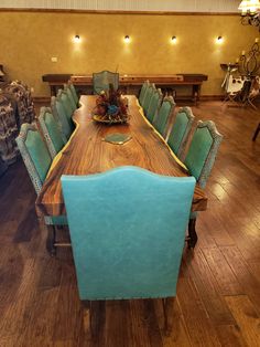 a large wooden table with blue chairs around it