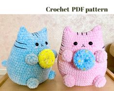 two crocheted cats sitting next to each other