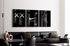 two black and white posters hanging on the wall above a couch in a living room