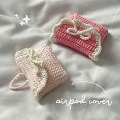 two crocheted purses sitting on top of a white bed next to each other