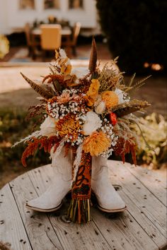 a bouquet of flowers is sitting on a wooden table