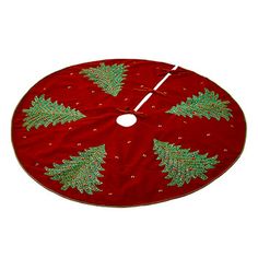 a red christmas tree skirt with green trees on it