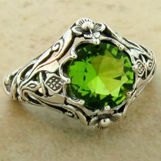 "Vintage Estate 1.50 Carat Green Simulated Peridot \"SCOTTISH THISTLE\" Solitaire Filigree Ring. Intricate Floral Details. 925 Solid Sterling Silver. The Top Of The Ring Measures 1/2 Inch In Length. Stamped 925. Excellent Condition/Like New Ring Sizes 5-10." Classic Silver Peridot Rings, Classic Silver Ring With Peridot, Elegant Peridot Jewelry Stamped 925, Elegant Stamped 925 Peridot Jewelry, Victorian Green Engraved Ring, Heirloom Peridot Jewelry For Anniversary, Elegant Green Engraved Rings, Elegant Engraved Green Rings, Classic Peridot Ring Jewelry