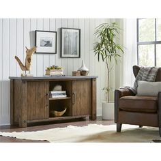 a living room with a chair, table and pictures on the wall