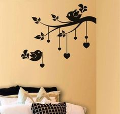 a bed room with a neatly made bed and wall decals