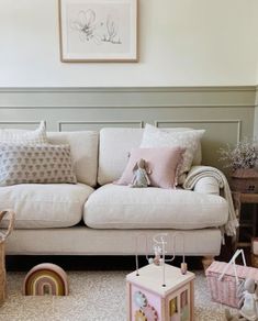 a living room filled with lots of furniture and decor on top of carpeted floors