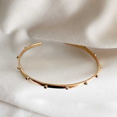 This simple solid gold cuff bracelet features 1.5mm lab grown brilliant cut diamonds all along the shaft. Feminine and minimal,  this solid gold cuff is classic yet modern - and as its made of solid gold it is perfect for everyday wear, yet unusual enough to make a delicate statement.  It would make a lovely gift for a special birthday or a modern way to celebrate an anniversary. This bracelet is made in your choice of solid  sterling silver 9k yellow, rose or white gold 14k yellow gold  18k rose, yellow or white gold.  PACKAGING AND GIFT WRAPPING  Every piece of Lily Flo Jewellery is wrapped up beautifully in our branded boxes and branded pouch ready to give or to receive as your special treat.  If you have ordered more than one piece, we will place it together in one box unless you've as Minimalist 14k Gold Cuff Bracelet Gift, Minimalist Tarnish Resistant Gold Plated Cuff Bracelet, Dainty Tarnish-resistant Bangle Cuff Bracelet, Minimalist Gold-plated Yellow Gold Cuff Bracelet, Minimalist Gold Plated Cuff Bracelet Gift, Adjustable Minimalist 14k Gold Bangle, Minimalist Yellow Gold-plated Cuff Bracelet, Minimalist Yellow Gold Plated Cuff Bracelet, Minimalist Yellow Gold Open Cuff Bangle