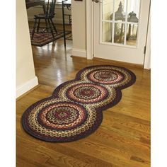 three rugs on the floor in front of a door